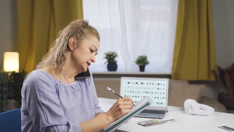 Woman-selling-products-online-taking-orders-on-the-phone.