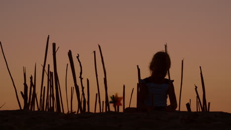 girl and bamboo barrier at summer sunset