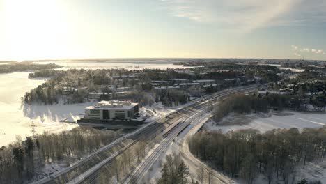 aerial view following traffic on road 170, winter sunset in herttoniemi, helsinki