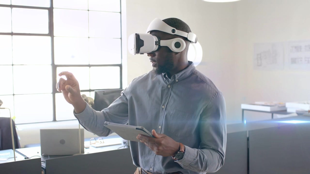 Man wearing VR holding tablet, tapping and pinching, activating tech UI for manipulating models