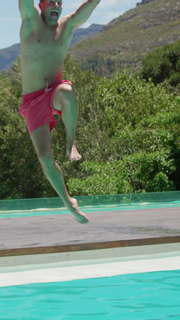 couple jumping in the swimming pool