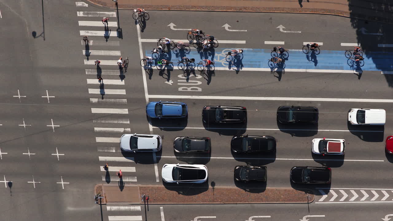 Aerial drone view of a large group of cyclists waiting at a traffic light in Copenhagen, Denmark
