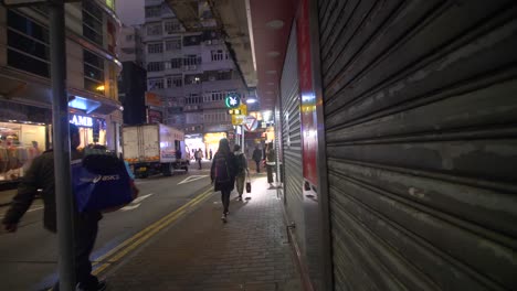 tracking backwards down hong kong sidewalk