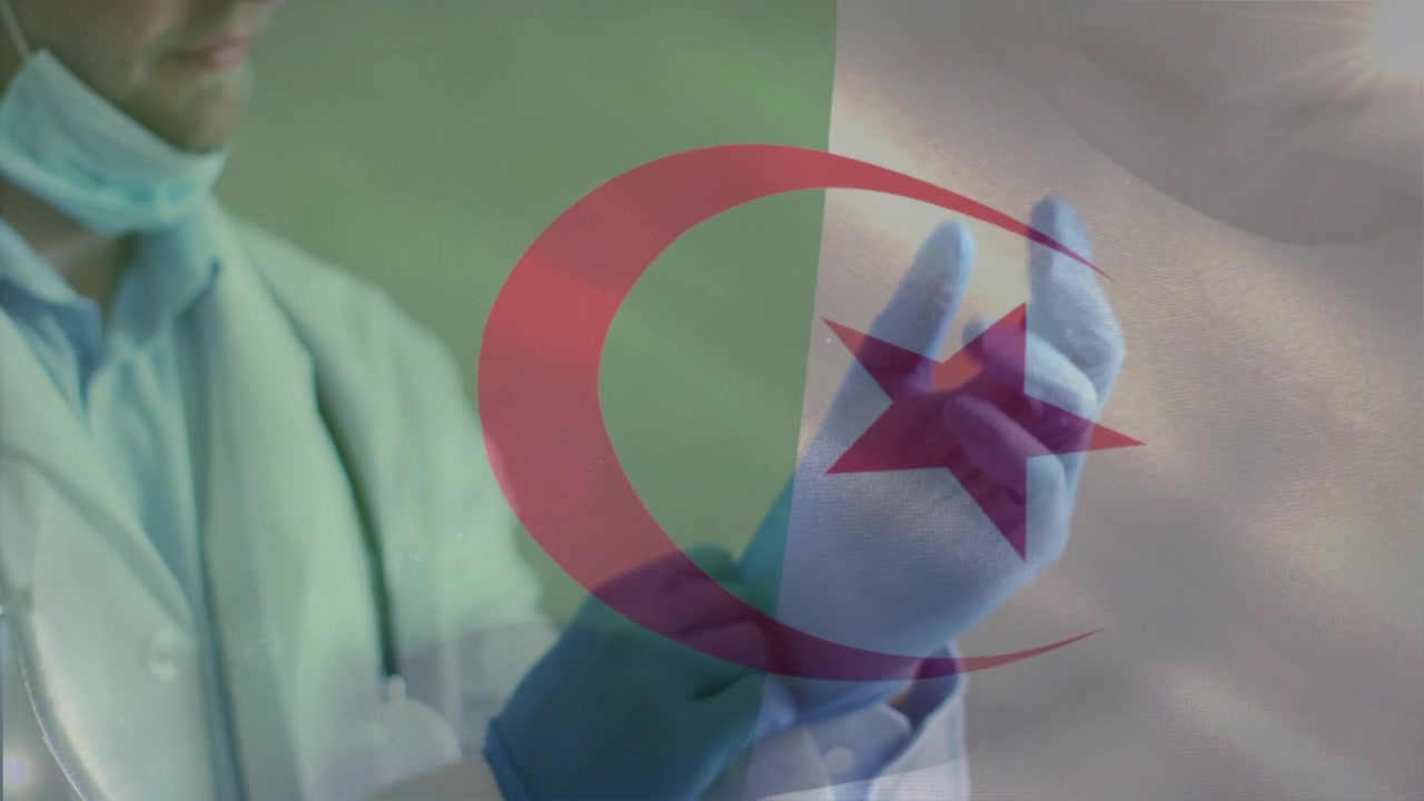 Doctor reaching donning and adjusting blue gloves while transparent flag overlaying, preparing exam
