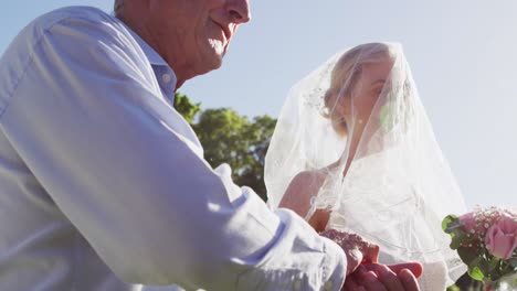 happy caucasian father walking daughter down the isle to the groom