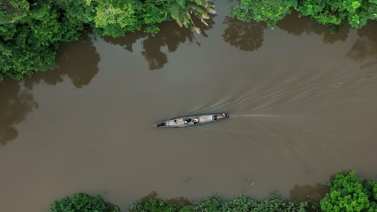 Ripresa aerea dall'alto di una barca che naviga sul Rio delle Amazzoni in Sud America in una giornata nuvolosa