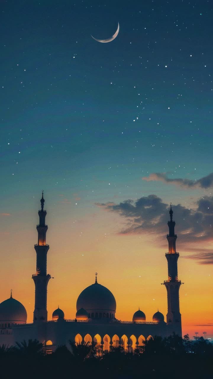 A serene video scene of a mosque at sunset, captured from a low angle, showcasing its silhouette