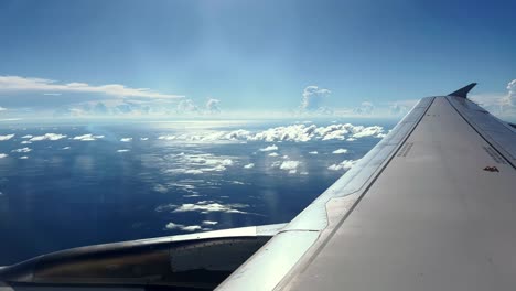 an aircraft flying over the blue water of the gulf of thailand