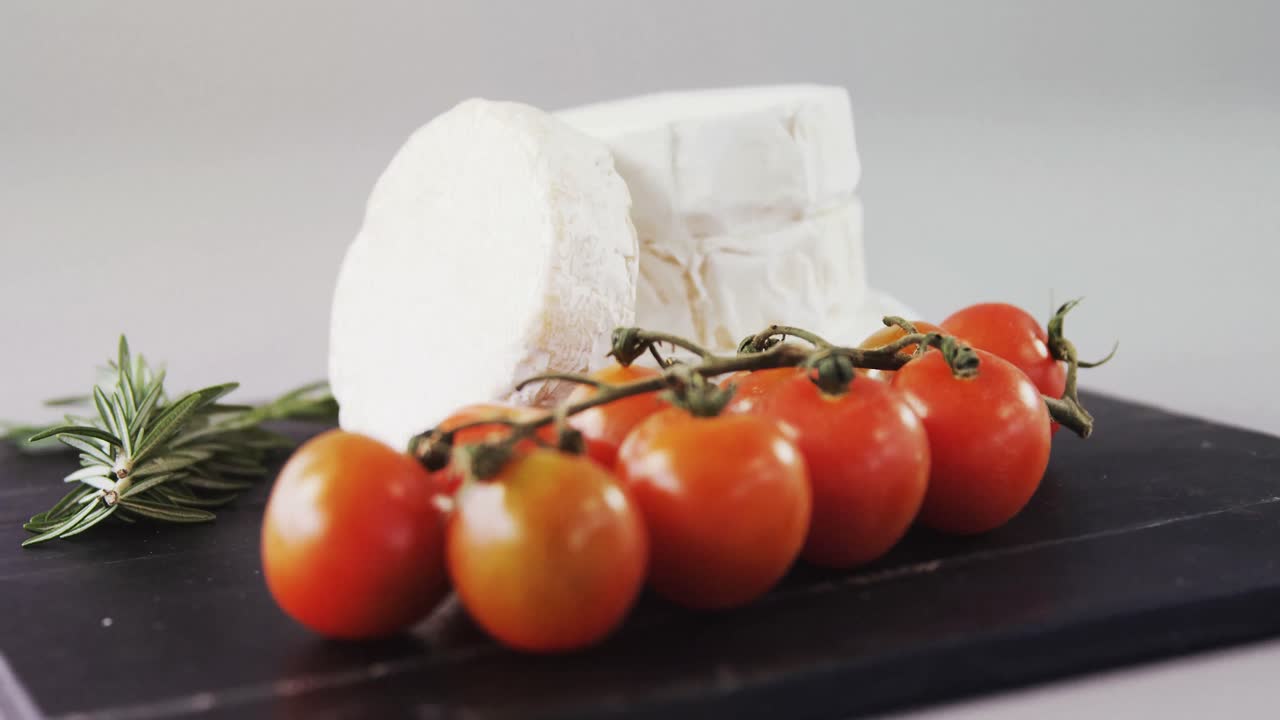 Cheese with tomatoes and rosemary herb