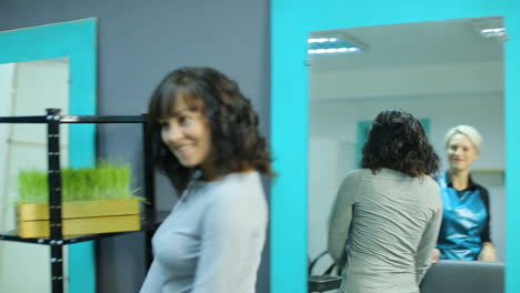 stylist dying hair. professional hairdresser dyeing hair of her client at beaty salon