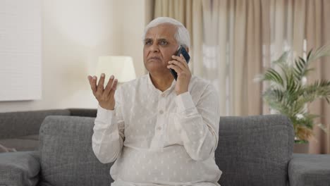 Indian-old-man-talking-on-phone