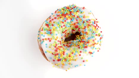 delicious sweet donut rotating at white background. colorful doughnut spinning