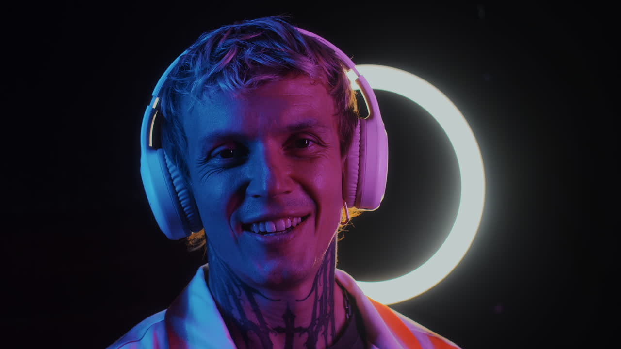 Handsome Guy Turning and Smiling to Camera in Neon