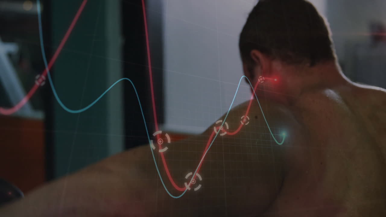 Shirtless male athlete monitoring AR chart in gym, displaying red blue lines with circular markers