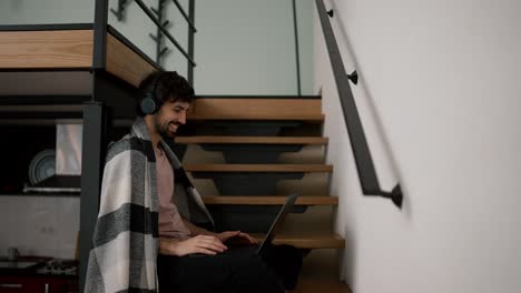 Caucasian-man-waving-hello-looking-to-screen-laptop-having-video-chat-with-friend-on-laptop