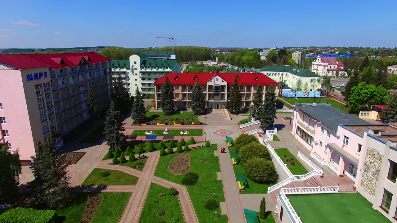 Newly built modern urban area with bright architecture. Sunny view of the provincial city on lovely summer day. Top view.