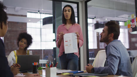 Mixed-race-businesswoman-having-a-meeting-with-colleagues-in-meeting-room