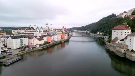 aerial over river danube and reveal of river ilz, with views over town passau, germany in early morning