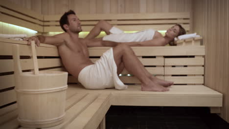 pareja descansando en la sauna caliente