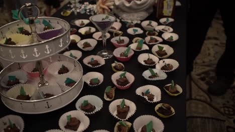 delicious brownies in paper cups placed on the buffet table - tilt-up shot