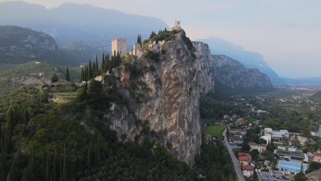 aerial view, castello di arco, medieval castle on steep cliff in riva del garda city, trentino, italy