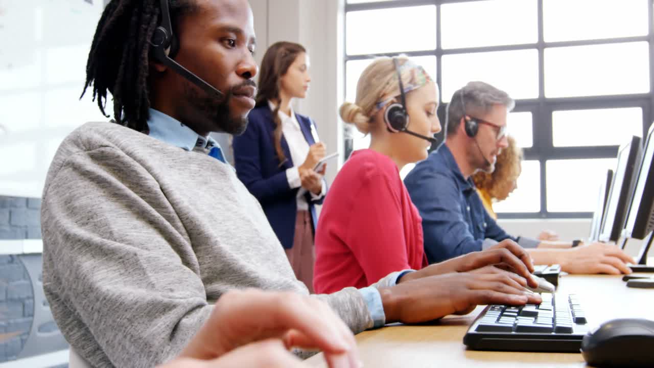 Business executives talking to client through headphone