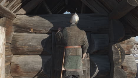 medieval warrior at a wooden hut