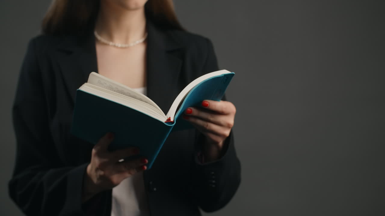 Businesswoman Reading a Notebook