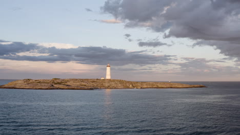 Lille-Torungen-Lighthouse-Against-Overcast-Sky-In-Arendal,-Norway---aerial-drone-shot