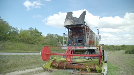 an old abandoned combine harvester in rural field - close up