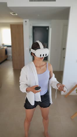 woman using vr headset and controllers at home