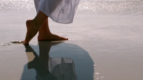 woman walking on the wet sand