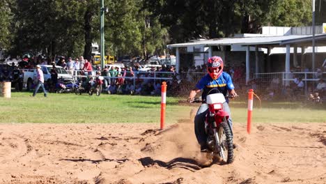 motorcyclist competes in a sandy obstacle race