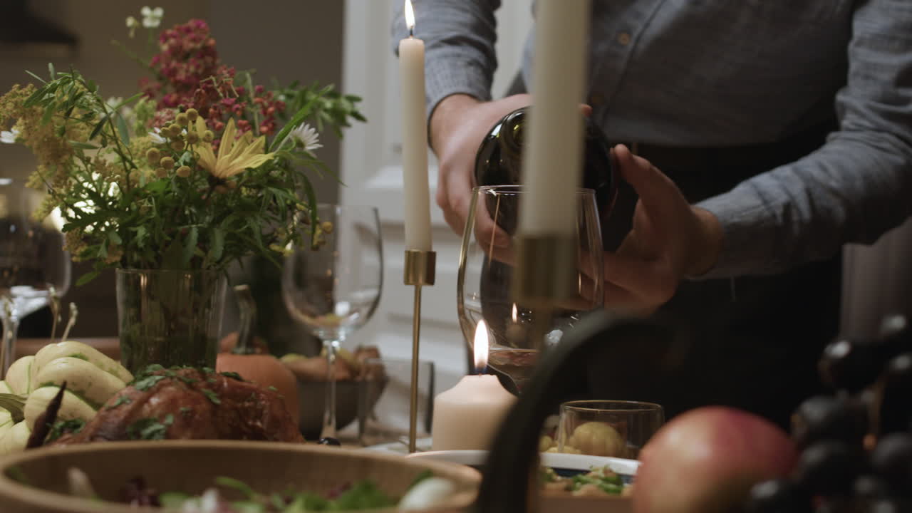 Pouring Wine at a Dinner Party