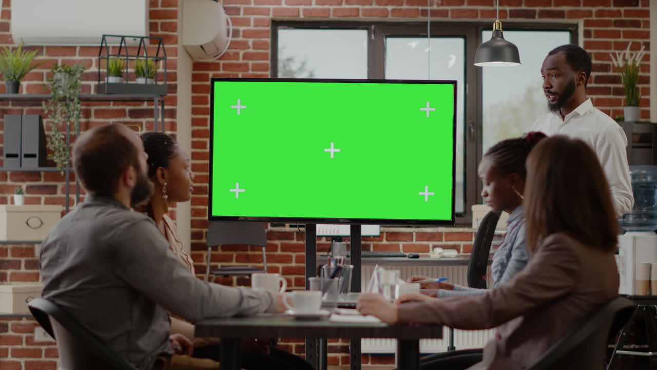 Business man presenting monitor with green screen