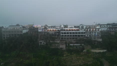 drone flying above the mountain towards the hotel which is located on the edge of the mountain