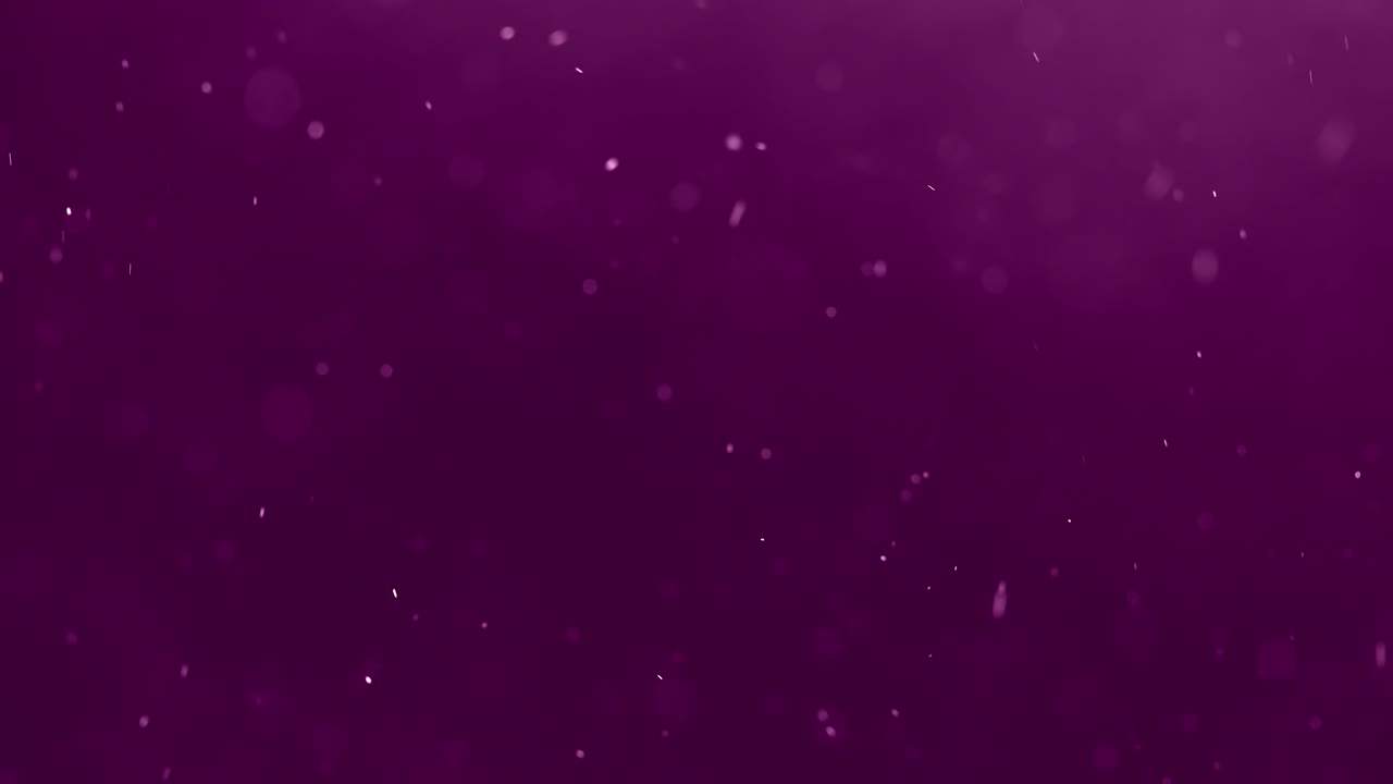 partículas flotantes sobre un fondo morado