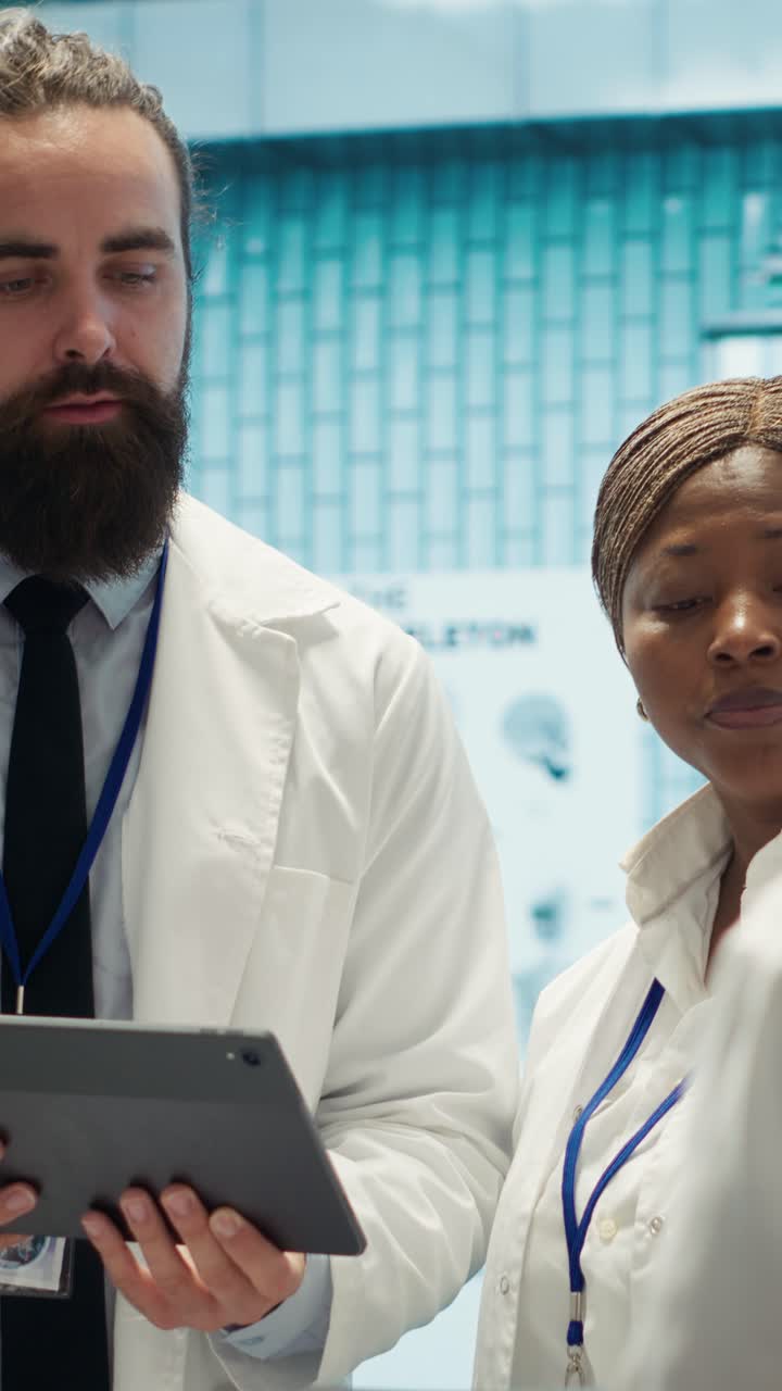 Vertical Video Physician and nurses reviewing medical charts and test results