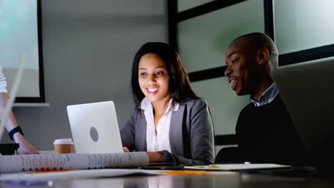 Business-colleagues-discussing-over-laptop-4k