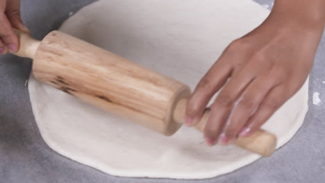 Making-Pizza-Dough,-Rolling-out-Pizza-Dough-with-a-Rolling-Pin