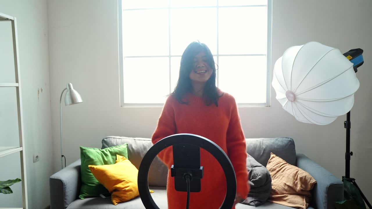 Young Asian Woman Recording a Video at Home
