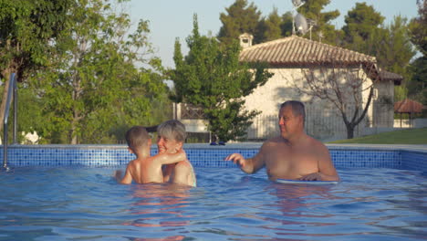 grandparents and grandson having fun in the pool