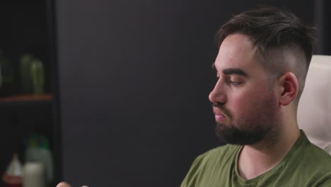 hungry man sitting at desk and eating a rice cracker 1