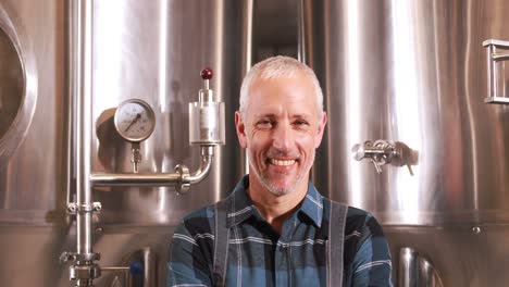 smiling brewery worker with thumbs up