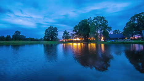 shot of spider on the camera lense while shooting a timelapse shot of lakeside cottage during sunset on a cloudy evening