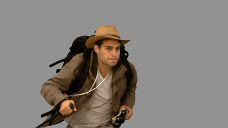 man orienteering while holding a hiking stick on grey screen