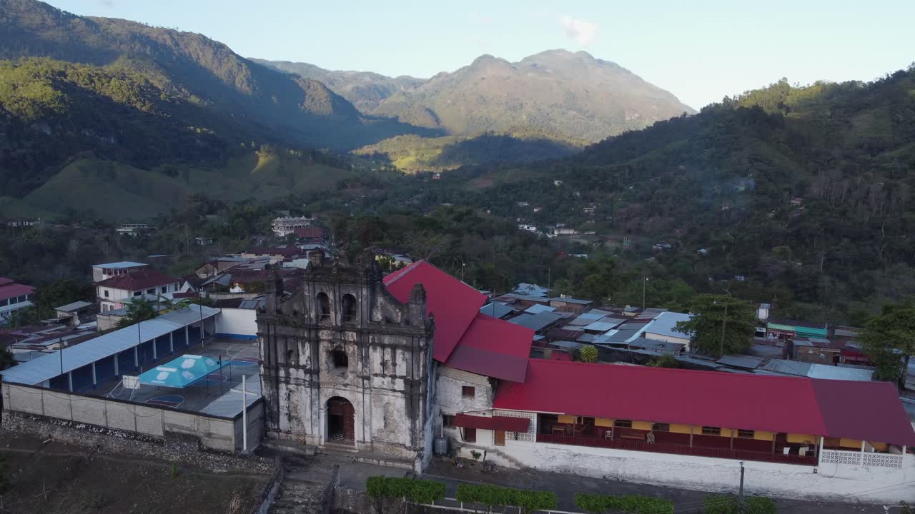 Aerial orbits dramatic fa&ccedil;ade of Lanquin Cathedral in Guatemala mtns