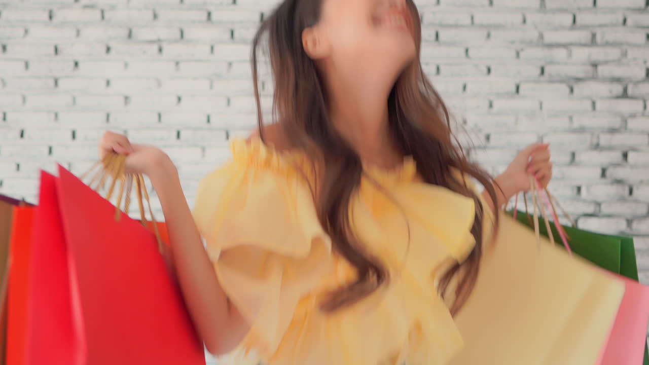 Woman jumping for happiness after shopping. Slow motion