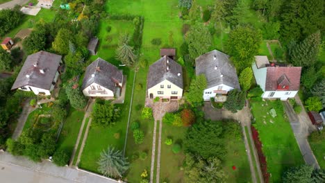 observing houses adorned with eternit roof coverings in austria - aerial drone shot