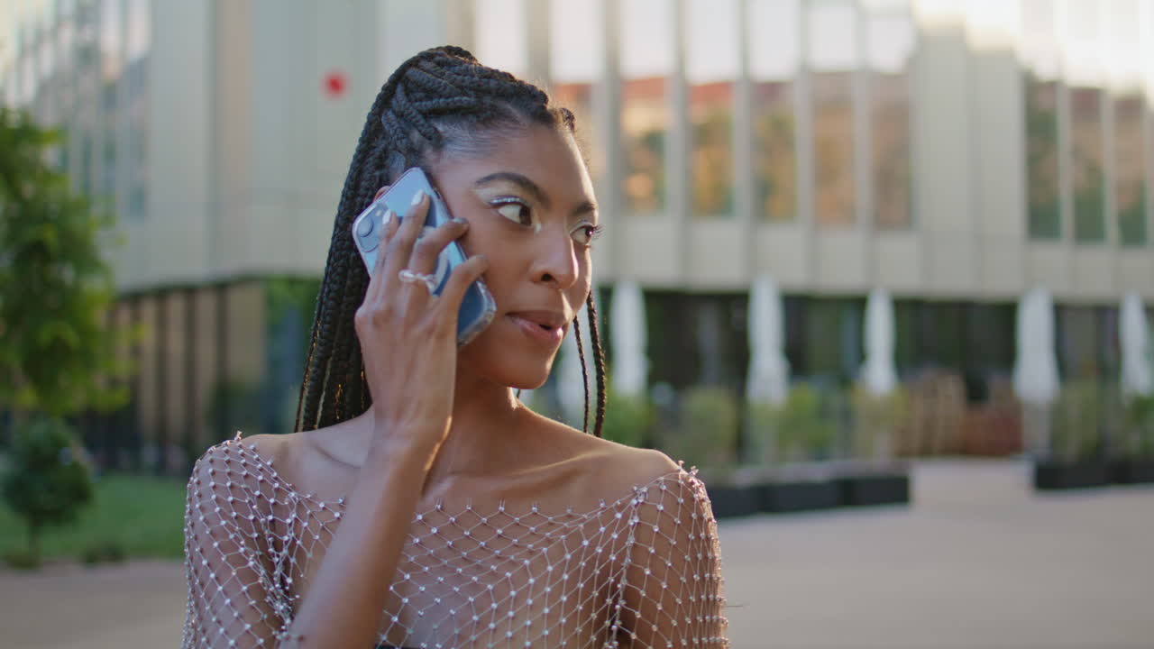 Black hair woman calling mobile phone at city street alone closeup. Girl talking